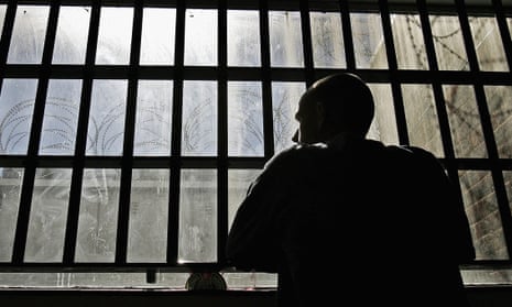 Young prisoner looks out of the window