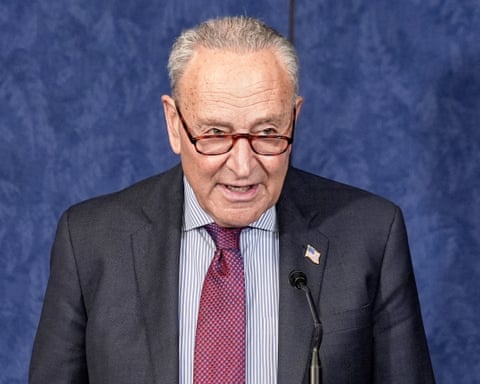 man in suit speaks into microphone