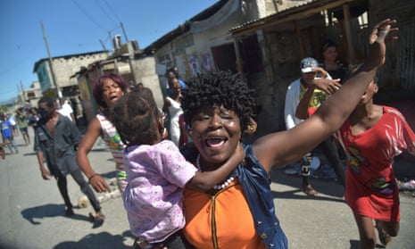 Haitians react to tear gas fired by the police in Port-au-Prince where there were reports of demonstrations, gunshots and burning tires. 