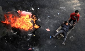 Iraqi demonstrators burn tyres in the city of Karbala during anti-government protests.