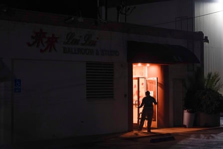 An investigator collects evidence from the door of Lai Lai Ballroom and Studio in Alhambra, California.