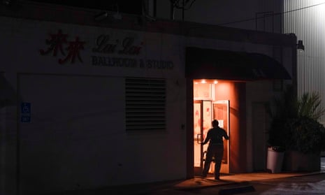 An investigator collects evidence from the door of Lai Lai Ballroom and Studio in Alhambra, Calif., Sunday, Jan. 22, 2023. The studio is located a few miles away from a ballroom dance club where a mass shooting took place following a Lunar New Year celebration. (AP Photo/Jae C. Hong)