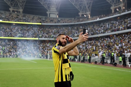 Karim Benzema takes a selfie in front of the fans at the King Abdullah Sports City in Jeddah