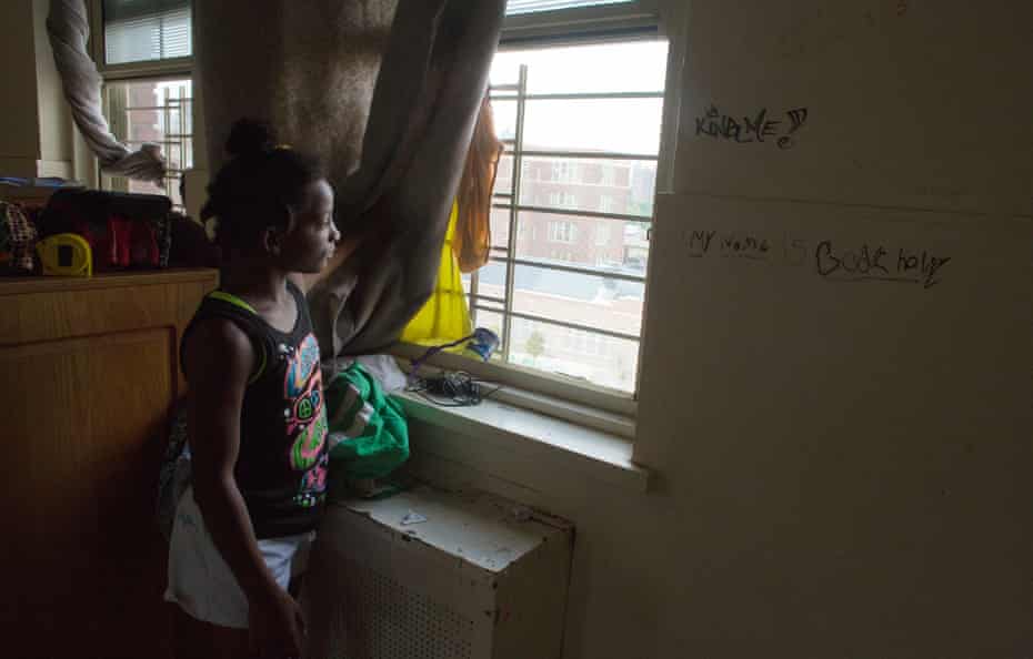 Dasani gazes out of the window from the one room her family of 10 share in a Brooklyn homeless shelter