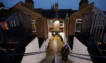A fan climbs the steps at the Kenilworth Road away end.