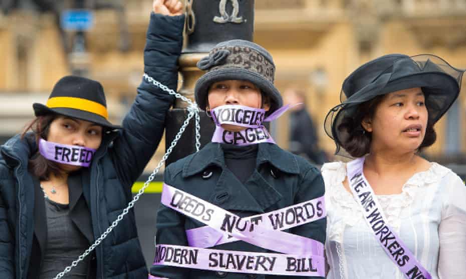 Domestic workers dressed as suffragettes demand the right to be able to change employers once in the UK at a protest in London in 2015