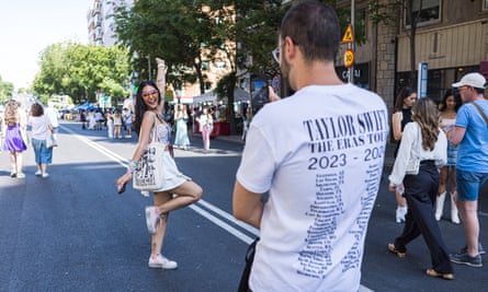 A Taylor Swift fan poses on a street