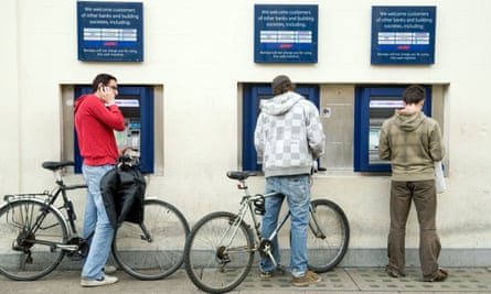 Students using the three Barclays bank ATMs in Market Square, Cambridge.