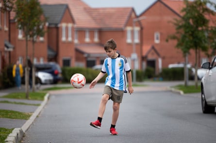 England’s united nations of football: 32 teams, one World Cup – and a lot of excited kids | World Cup 2022 5 Toby Donald from Salisbury playing football on a residential street wearing an blue-and-white striped Argentina shirt