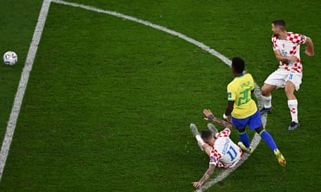Vinicius Junior shoots past Croatia's midfielder Marcelo Brozovic and Mateo Kovacic