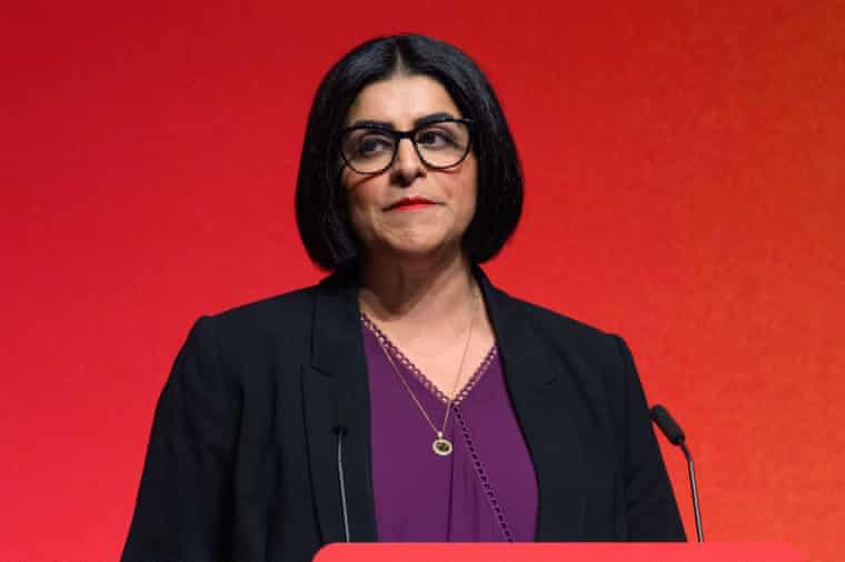 Shabana Mahmood MP speaks at a podium against a red background at a conference