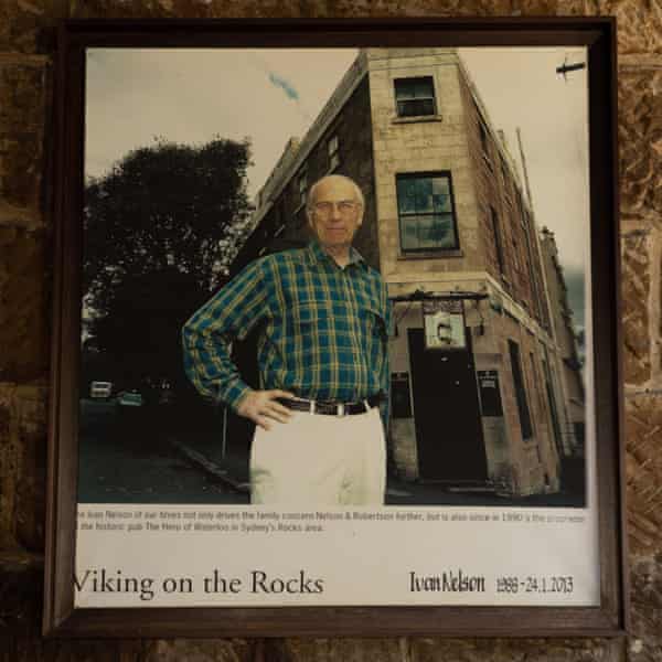 A picture frame hangs on a sandstone wall