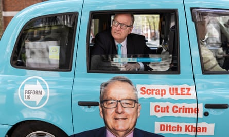 Howard Cox in the back of a blue London taxi