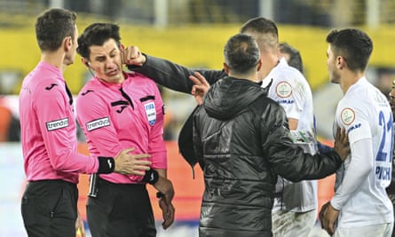 Referee Halil Umut Meler was escorted away by police after the incident.