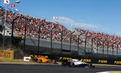 McLaren’s Fernando Alonso heads off the track thanks to the attentions of Lance Stroll at Suzuka