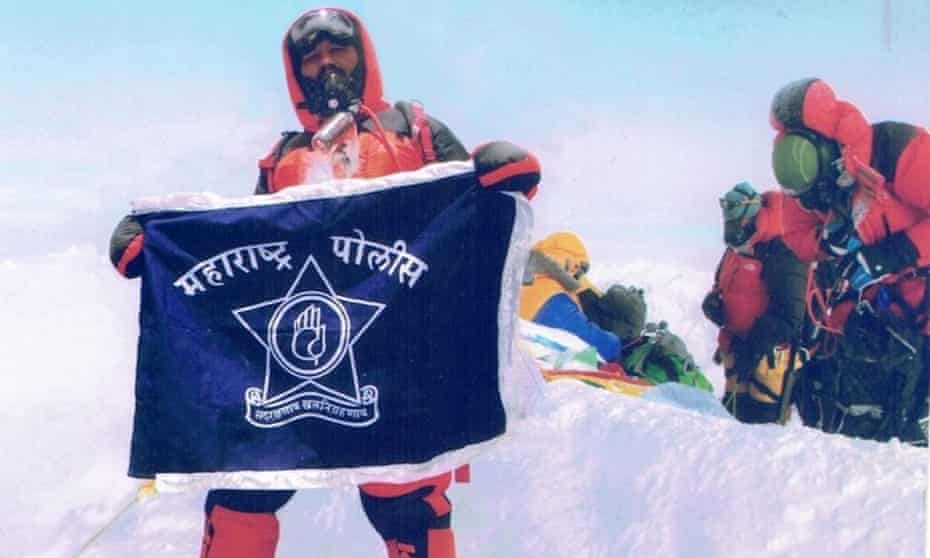 Dinesh Rathod with and Indian flag on Mount Everest. It is claimed the photo is faked