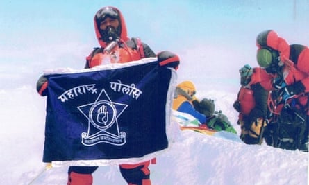 'Fake' mountaineer Dinesh Rathod with his flag. It has been claimed that this image of him and his wfie at the summit of Mount Everest was faked.