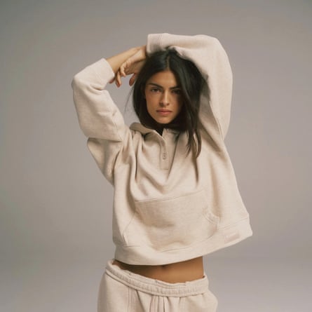 A model wears the Loopback Henley hoodie in Oatmeal