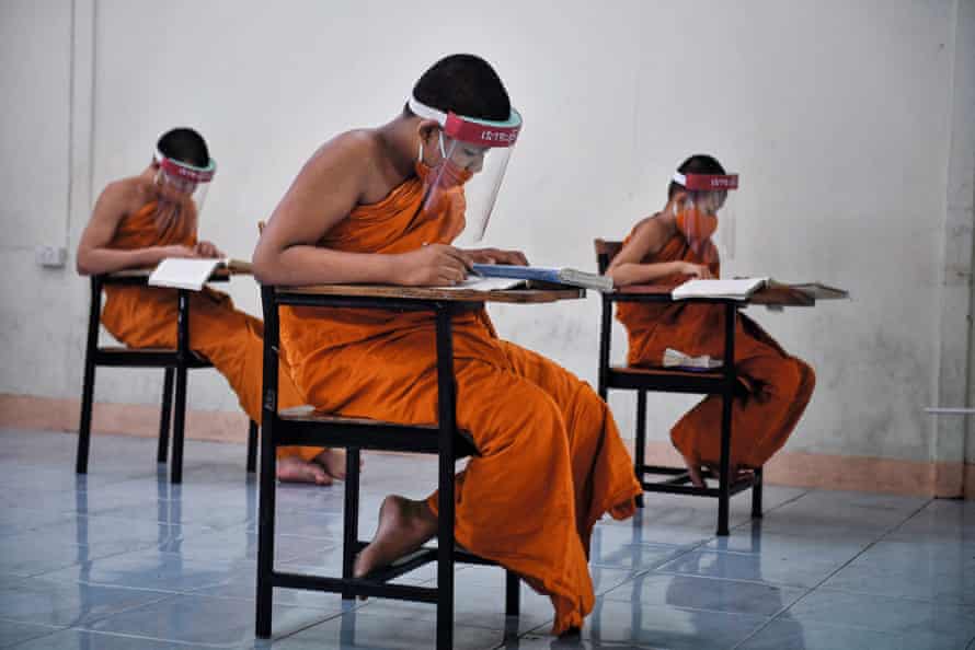 Novice monks wearing face shields at Wat Molilokkayaram Buddhist temple in Bangkok, April 2020, from The Year That Changed Our World