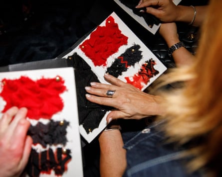 People touch fabric swatches.