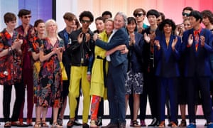 British designer Paul Smith is applauded by his models