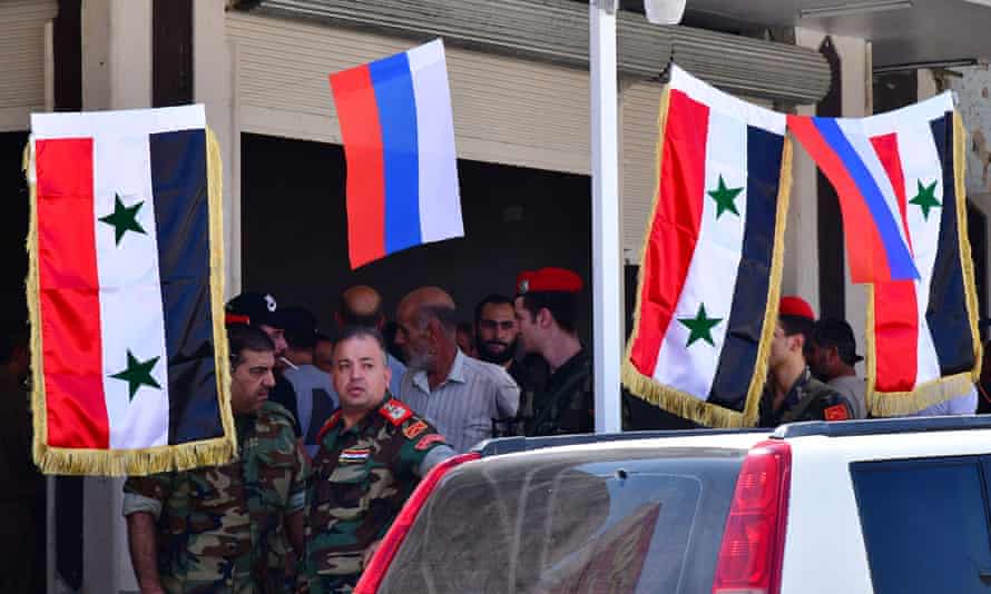 What’s next for American foreign policy? | Afghanistan 5 Russian flags sit next to Syrian ones in Daraa province, southern Syria.