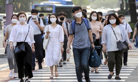 Office workers wearing masks head home after work in Seoul on Wednesday.