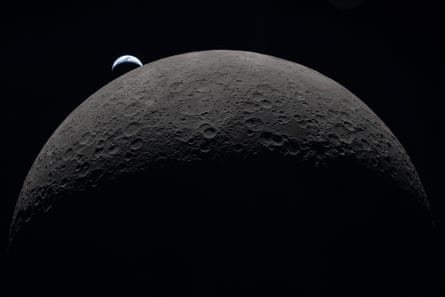 Earth setting over the Moon’s curved limb as seen from the Orion spacecraft.