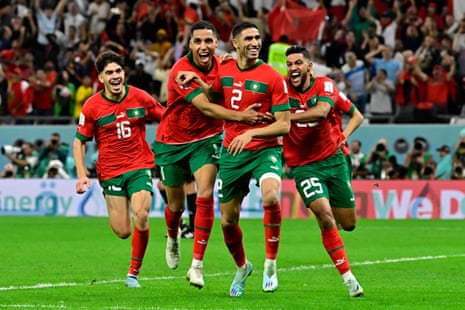 Morocco's defender Achraf Hakimi (C) celebrates with his teammates after converting the last penalty during the penalty shootout win against Spain.