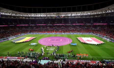 The players and match officials take to the pitch.