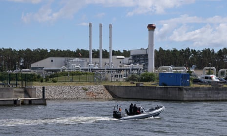 A police boat motors past the receiving station for the Nord Stream 1 natural gas pipeline near Lubmin, Germany, today.