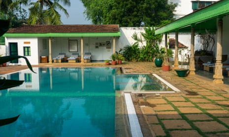 An outdoor swimming pool with shaded verandas on two sides