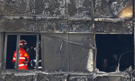 Firefighters survey the damage inside Grenfell Tower.