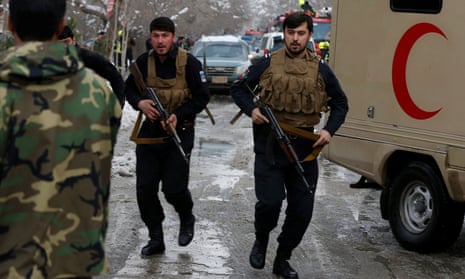 Afghan police officers arrive at the site of a bomb blast in Kabul.