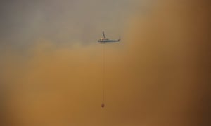 A water-bombing helicopter fighting a bushfire on outskirts of Balmoral on Friday.