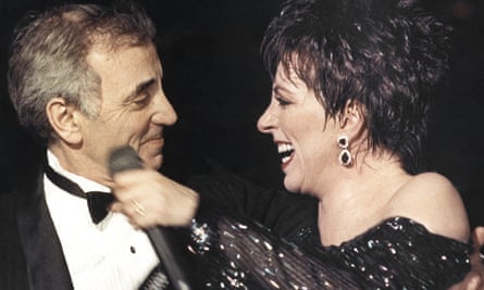 Liza Minnelli welcoming Charles Aznavour on to the stage at the end of her show at the Lido cabaret in Paris, 1987.