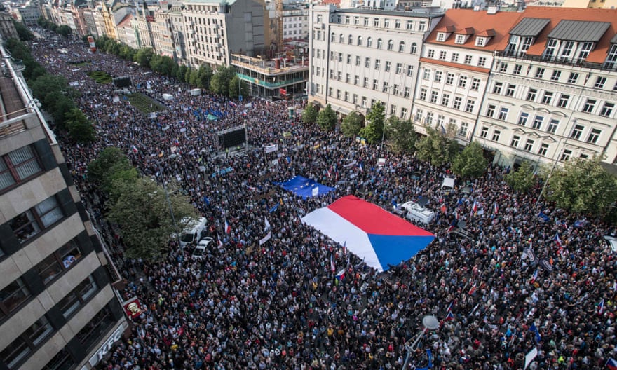 Demonstrators hold up a Czech and an EU flag during an anti-government protest in Prague in May
