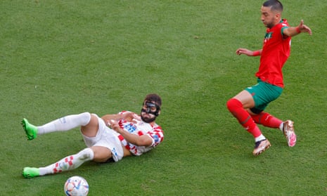 Croatia's defender Josko Gvardiol (L) makes a sliding tackle.