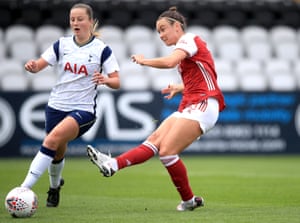 Arsenal’s Caitlin Foord shoots the ball past Tottenham Hotspur’s Anna Filbey to score her side’s third goal.