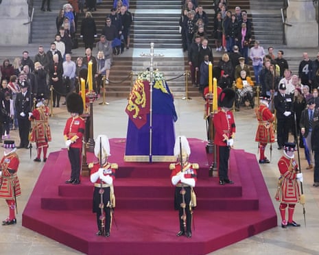 Members of the public pay their respects as they walk past the coffin of Queen Elizabeth II, draped in the Royal Standard with the Imperial State Crown and the Sovereign's orb and sceptre, lying in state on the catafalque in Westminster Hall, London, Thursday, Sept. 15, 2022. (Yui Mok/Pool Photo via AP)