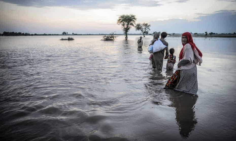 Flood victims try to reach safe zones after their homes submerged under the flood water in Jalapur Bhattian, Pakistan.