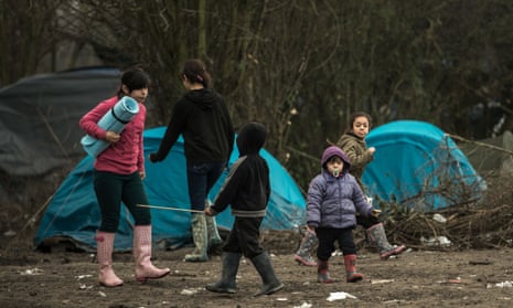 Children walk through the refugee camp of Grande-Synthe, near Dunkirk