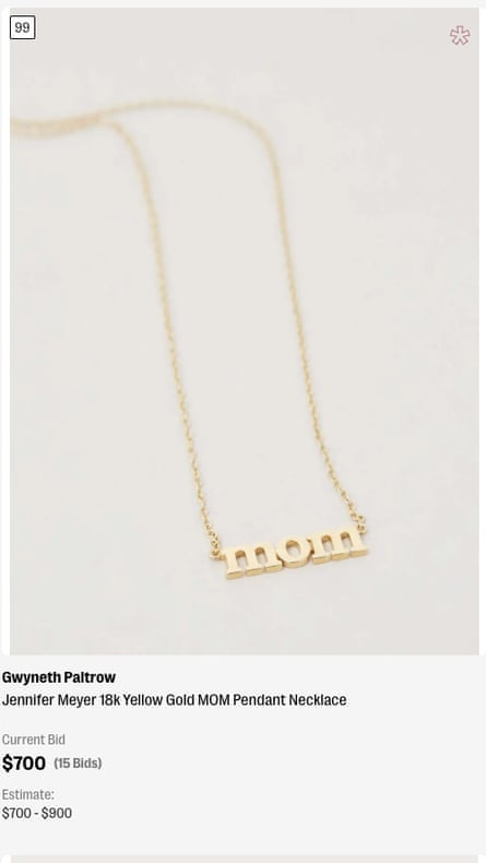 A gold necklace with the word “mom”