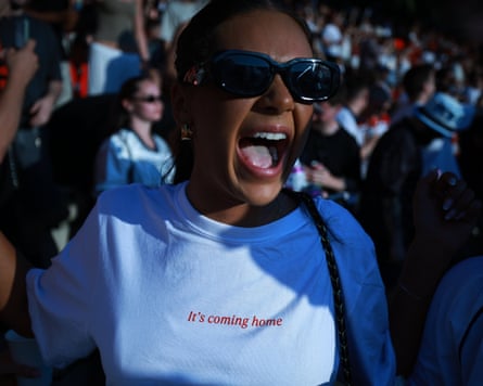 A young woman wearing a T-shirt saying ‘It's coming home’ screams in excitement.