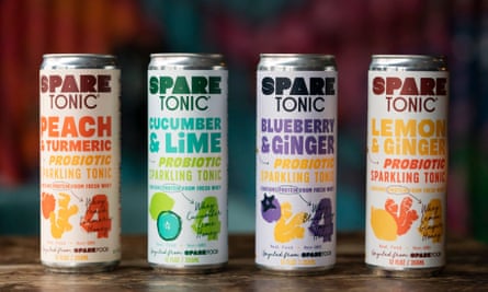 A stock image of four tall, skinny, brightly colored cans of Spare Tonic, with the flavors peach and turmeric, cucumber and lime, blueberry and ginger, and lemon and ginger.