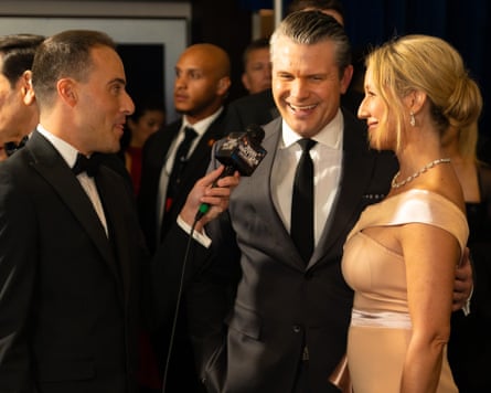 An interviewer talking to Pete Hegseth and Jennifer Rauchet