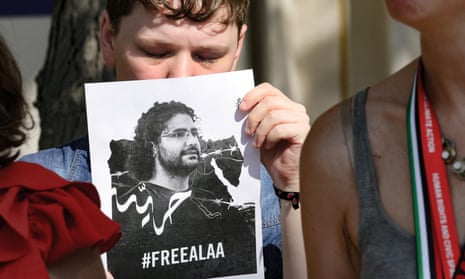 An Amnesty international activist holds a portrait of imprisoned Egyptian-British blogger Alaa Abd el-Fattah, during a protest to demand the release of activists from jails, at the United Nations climate summit in Dubai on Saturday December 9, 2023.