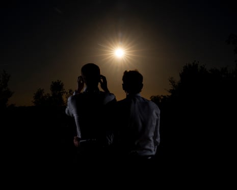 Grooms Jerry Bone, 30, and Jamie Bone, 25, take a moment during their wedding day to watch the solar eclipse in Alpheton, Suffolk.