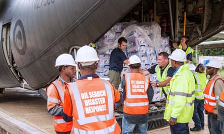 New Zealand military personnel unload aid supplies as part of emergency relief efforts in the Highlands region.