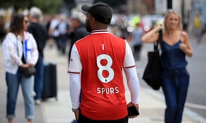 An Arsenal fan wanders around the Emirates in his personalied shirt.